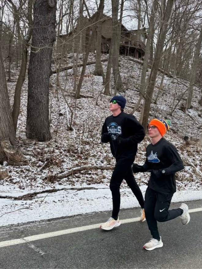 PRACTICE MAKES PERFECT Jonah Kaplan ‘26 and Henry Beck ‘26 training for their upcoming indoor track season. “Practice like you play,” said Kaplan as he finished the pre-meet run.